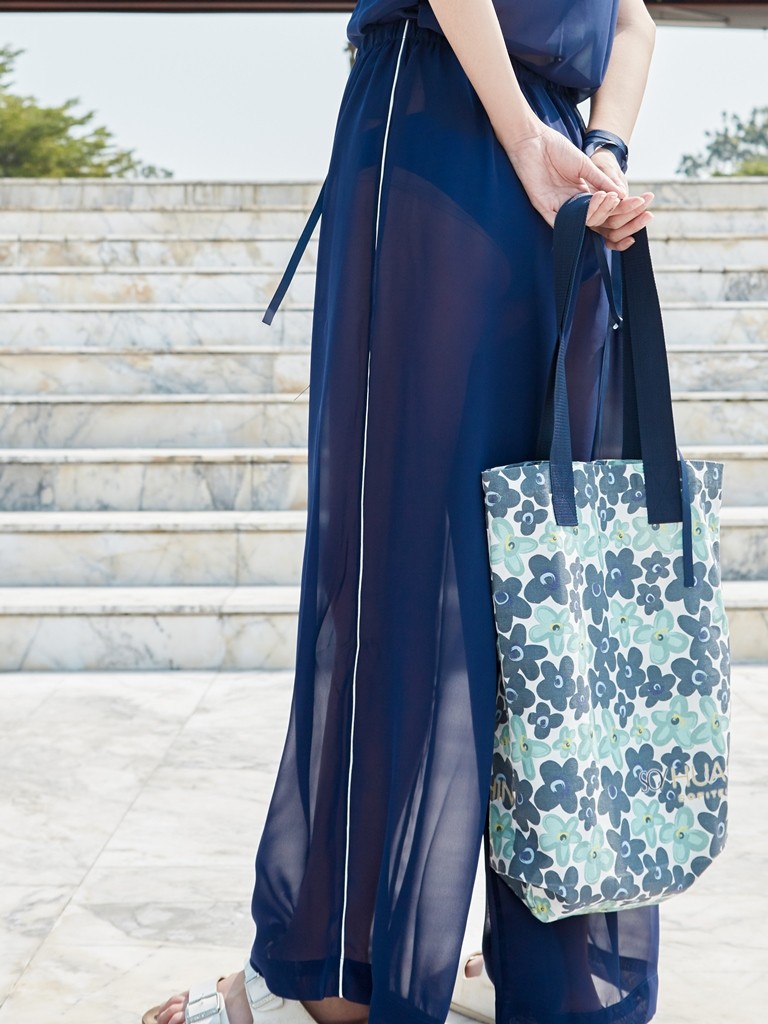 https://www.so-sofitel-huahin.com/wp-content/uploads/sites/73/2018/02/Blue-Pants-with-Floral-Tote-Bag.jpg